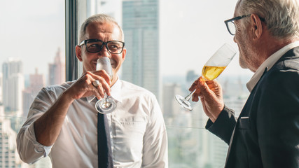business background of caucasian businessman having glass of champange on hands and drinking together