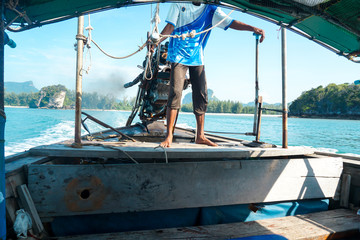 Long tail boat drivers at sea are driving motor surfing in Thailand.