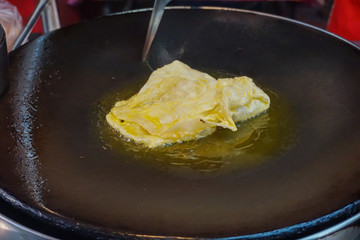 Roti fried on a frying pan in the roadside oil in Thailand