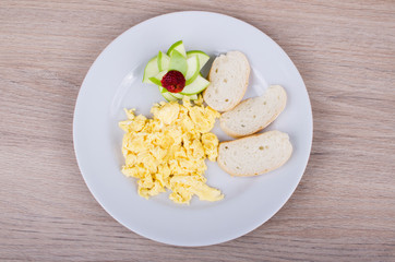 scrambled eggs with bread and fruit
