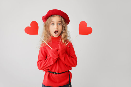 Cute Little Girl With Red Hearts On Grey Background. Valentines Day Celebration