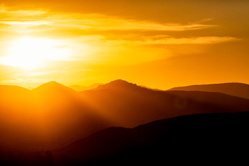 Fototapeta na wymiar Sunrays over Mountains at SUnset