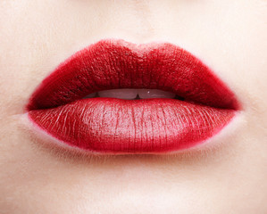 Closeup macro portrait of female red smiling lips with day beauty makeup.