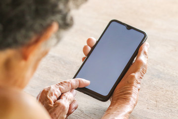 Old woman holding smart phone for shpping online