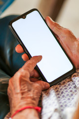 Old woman holding smart phone for shpping online