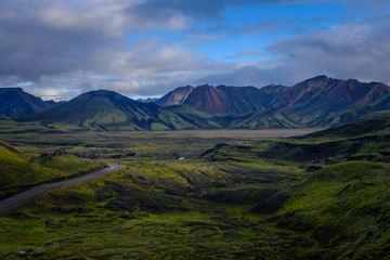 Fototapeta premium Iceland in september 2019. Great Valley Park Landmannalaugar, surrounded by mountains of rhyolite and unmelted snow. In the valley built large camp. Evening in september 2019