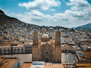 Aerial shot of the cathedral in Zacatecas Mexico under a blue cloudy sky