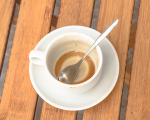 Top view empty white ceramic cup of traditional Vietnamese coffee on wooden table