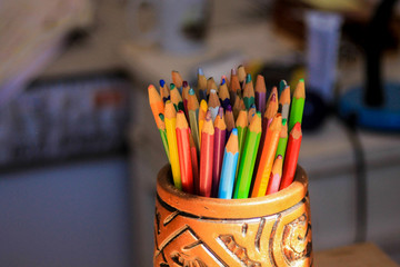 Colored pencils in a ceramic cup