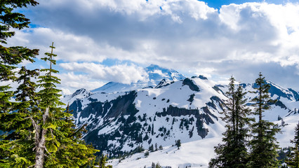 Mount Baker Glaciers. Washington, USA. Snowy peak through clouds seen from Artist Point.