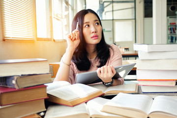 Young woman using tablet in a library