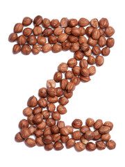 Letter Z of the English alphabet from from hazelnut on a white isolated background. Food pattern made from nuts. Bright alphabet for shops.