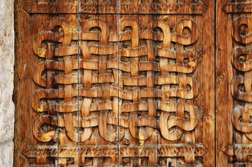 Ornamented surface of the carved wooden door