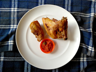 Traditional indonesian culinary food. sambal and ayam goreng or fried chicken with chili sauce. Ayam Goreng Indonesian Food that is simple and often made at home.