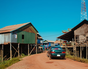 Car on the yellov road in Floating Village, Cambodia