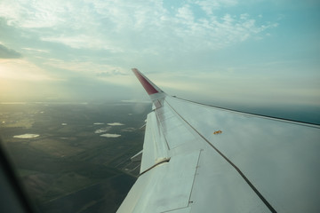 Aiplane windows view on aircraft wing from the cabin, skyline transportation