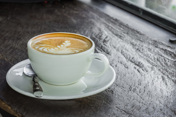 cup of coffee on wooden table