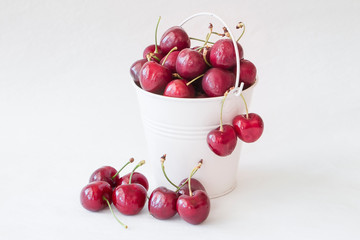 Cherries in a saucepan on a white background
