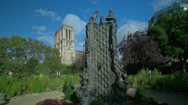 Square Rene Viviani and the Notre Dame Cathedral in the background, Paris, France. The fountain is the work of George Jeancloss,1995, and it represents the legend of St. Julien the Hospitaller