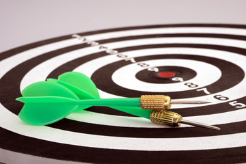 Green darts on the dart board.