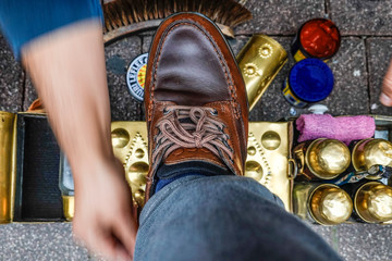 Istanbul, Turkey A man gets his boots shined by a shoe shiner on the street.