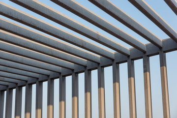 Partial close-up geometric figures of an iron pillar railing frame under sunlight