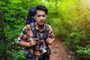 man traveler with backpack in the forest