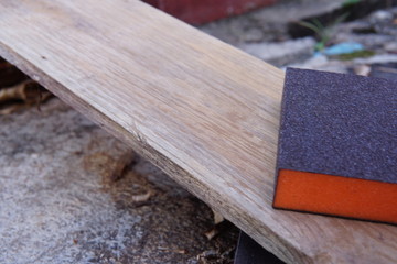 Sandpaper for polishing wood Laying on a wooden plate.