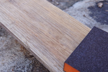 Sandpaper for polishing wood Laying on a wooden plate.