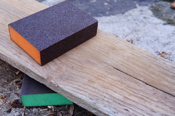 Sandpaper for polishing wood Laying on a wooden plate.
