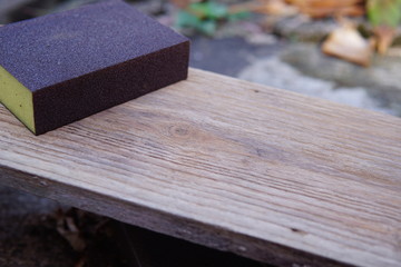 Sandpaper for polishing wood Laying on a wooden plate.