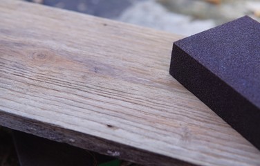 Sandpaper for polishing wood Laying on a wooden plate.