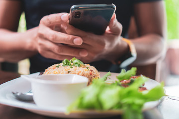 Man taking photo on cellphone on dish in restaurant beautiful communication in social networks.