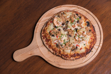 Tuna pizza with shrimp and pineapple, isolated, top view.