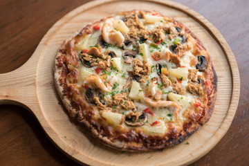 Tuna pizza with shrimp and pineapple, isolated, top view.