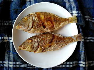 Traditional indonesian culinary food. Ikan Goreng or fried fish. Ikan Goreng Indonesian Food that is simple and often made at home. Indonesian Street Food.