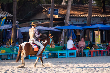 Prachuab Khirikhan, Thailand - November, 16, 2019 : Unidentified name people riding a horse in sunset time at Huahin beach of Prachuap Khiri Khan,Thailand