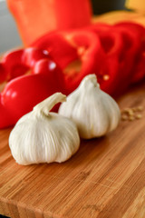 Ingredients used to make an Italian meal. Tomatos, bell peppers, garlic and spagetti 
