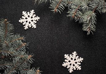 Christmas concept background. Snowflakes on black glitter paper background.