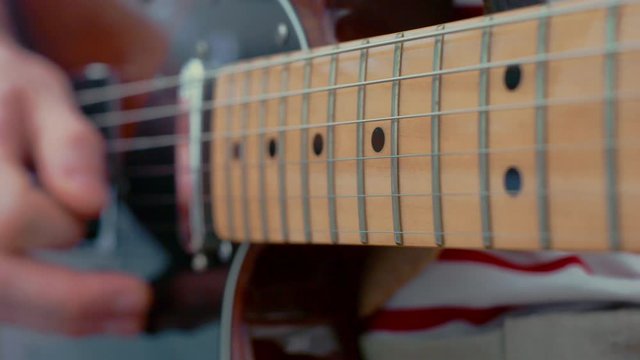 Close up playing electric guitar