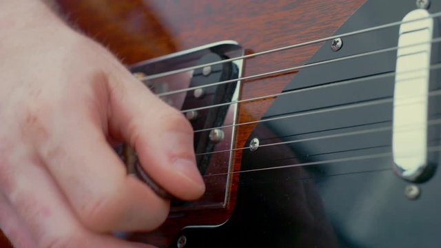 Close up playing electric guitar