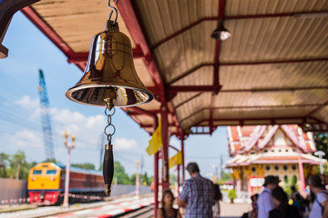 Prachuap Khiri Khan,Thailand - November, 16, 2019 : Gold bell on red wooden pole at the famous train station in Hua Hin. Selective focus on gold bell. Railway of Thailand.