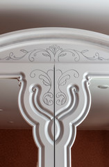 Fragments of white furniture in the old style close-up.