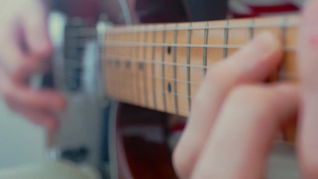 Close up playing electric guitar