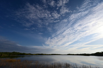 Sunrise cloudscape reflected on calm water of Nine Mile Pond in Everglades National Park, Florida.