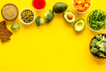 Healthy food. Vegatables and fruits on yellow background top view frame copy space
