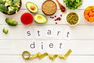 Poster Start diet text near healthy food on white wooden background top view © 9dreamstudio