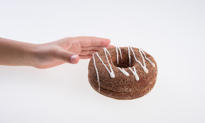 Donut or Donuts with hand on a background new.