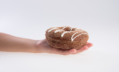 Donut or Donuts with hand on a background new.