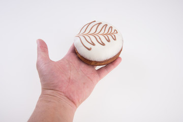 Donut or Donuts with hand on a background new.